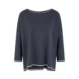 A dark navy blue long-sleeve top with white contrast trim along the neckline, cuffs, and hem, displayed against a light gray background.