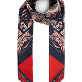 A silk scarf with a navy blue base, featuring a detailed beige and red paisley pattern on the top and a solid red geometric pattern on the bottom, displayed on a light gray background.