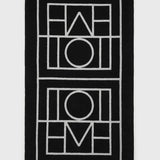 Toteme Monogram Beach Towel in Black and Tofu