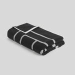 Toteme Monogram Beach Towel in Black and Tofu