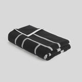 Toteme Monogram Beach Towel in Black and Tofu