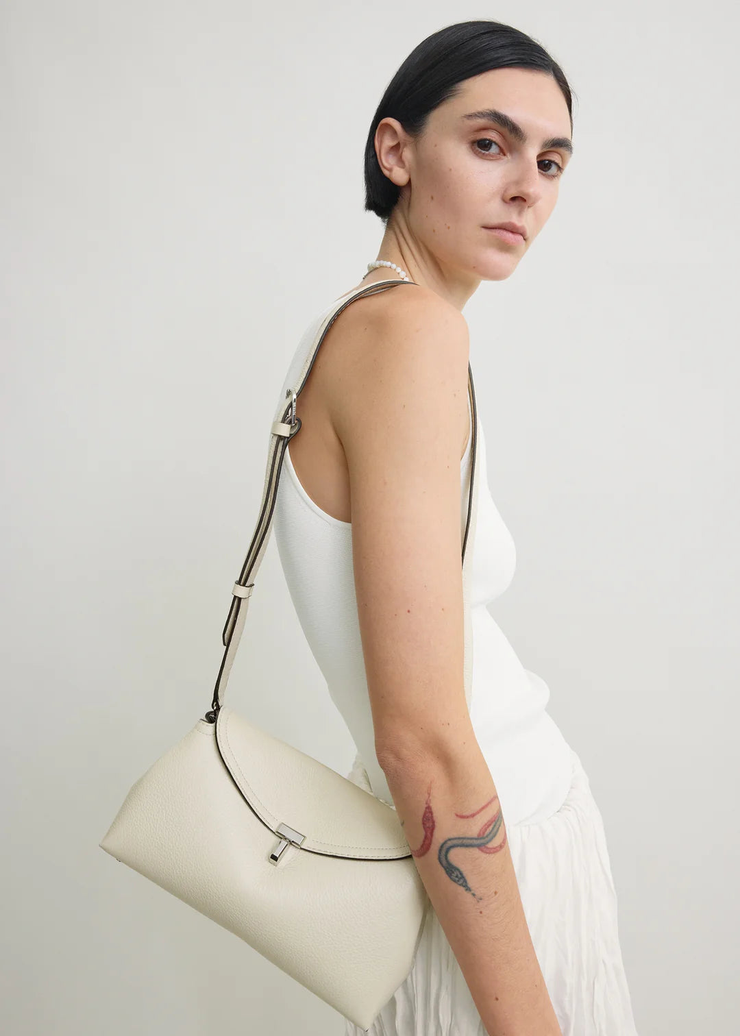 Toteme T-Lock Grained Leather Clutch in Milk