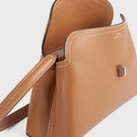 Toteme T-Lock Grained Leather Clutch in Tan