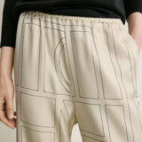 Toteme Monogram Silk PJ Bottoms in Ivory - close up