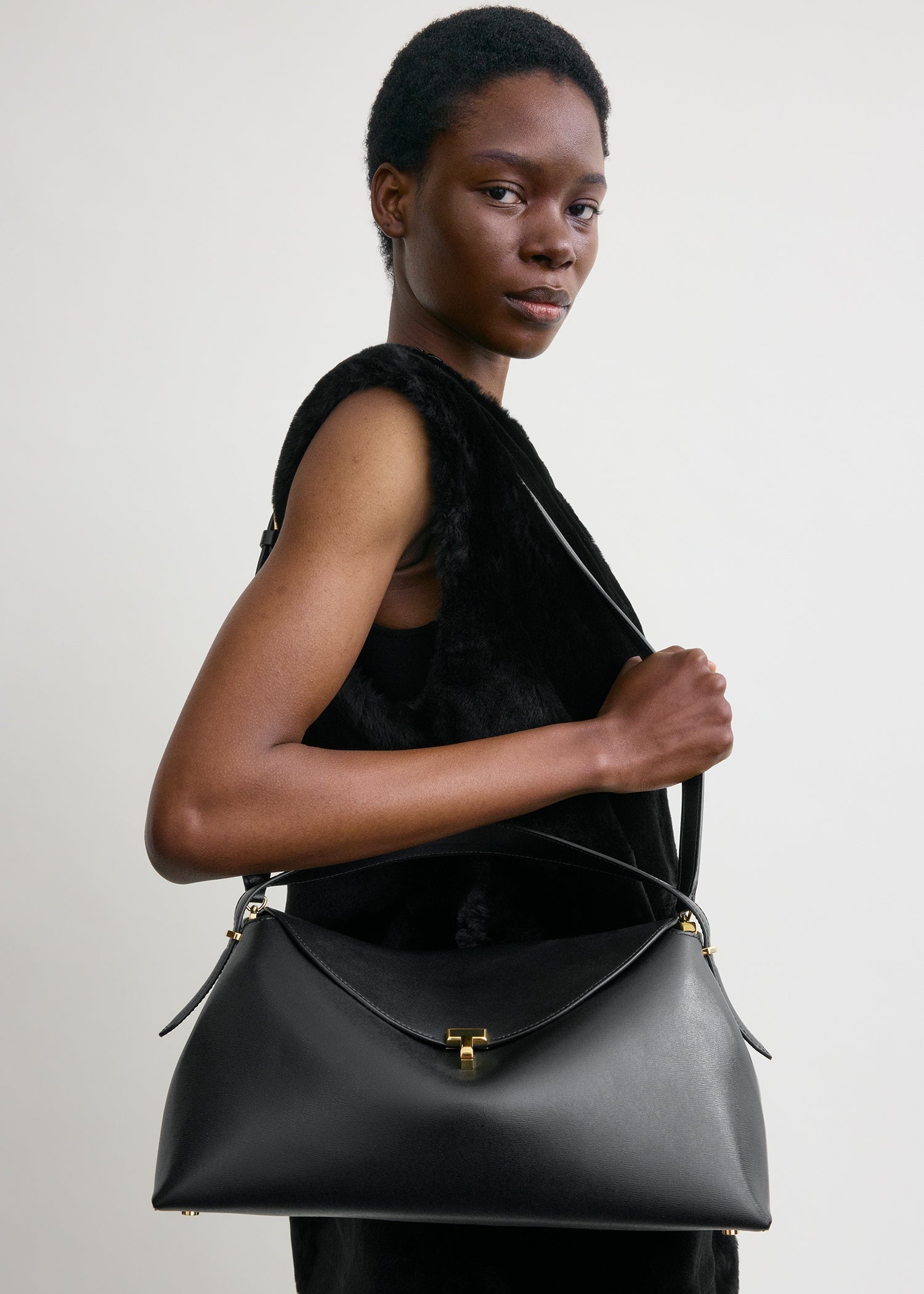 Toteme T-Lock Leather Top Handle in Black - detail view
