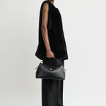 Toteme T-Lock Leather Top Handle in Black - side view