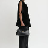 Toteme T-Lock Leather Top Handle in Black - side view