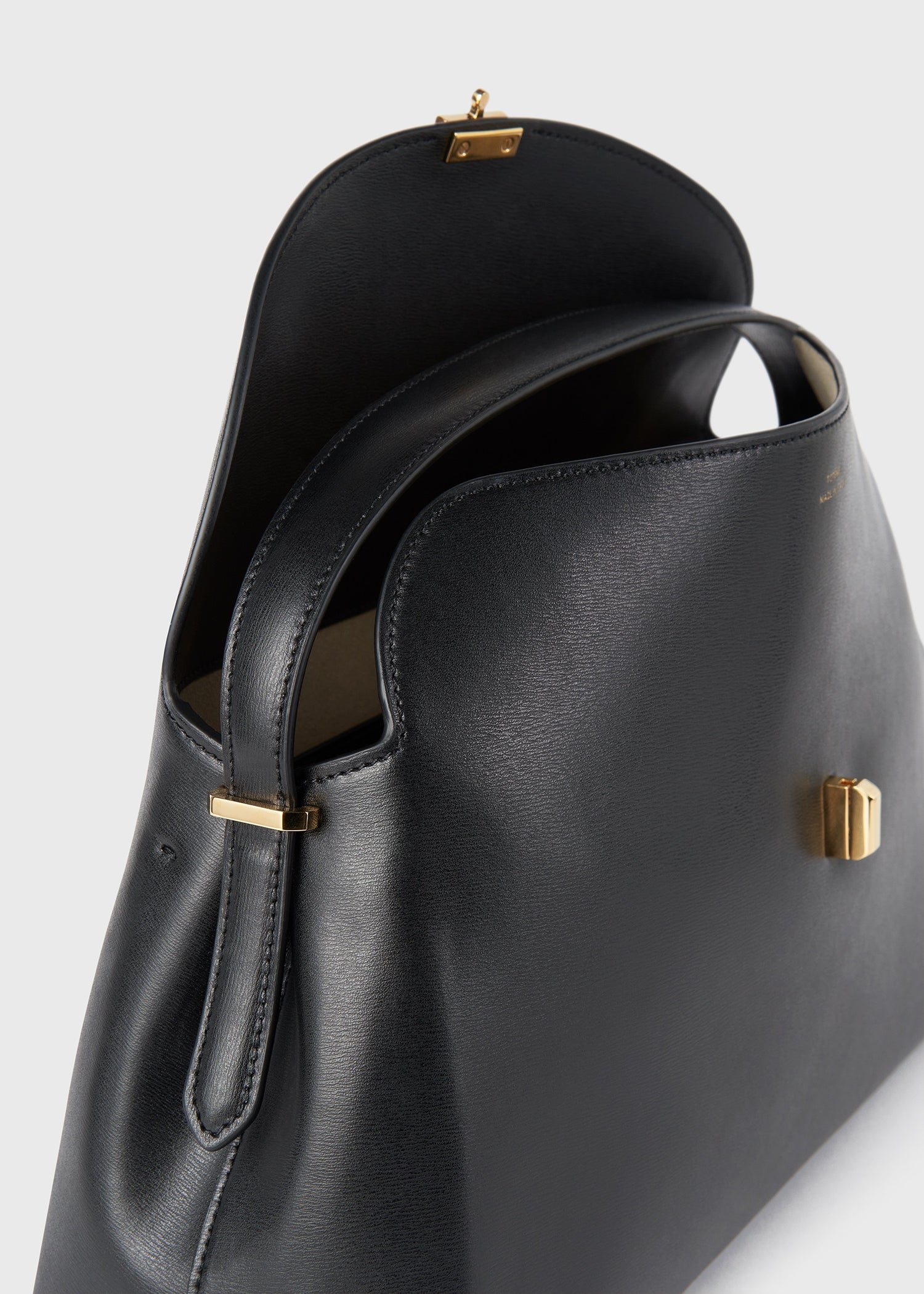Toteme T-Lock Leather Top Handle in Black - outfit inspiration