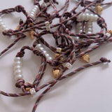 Petite Chou Le Piscine and Pearl Bracelet on Brown Cord