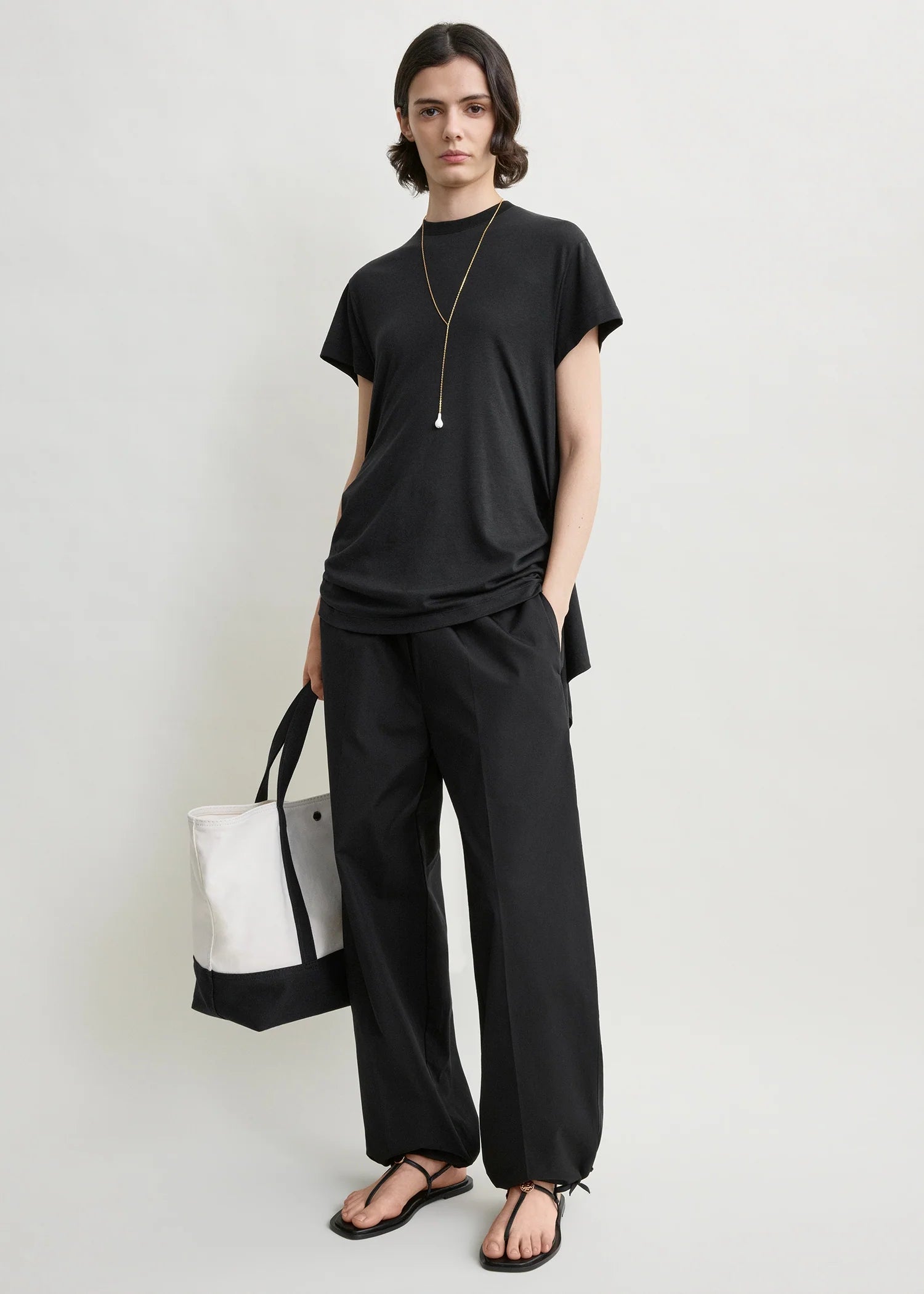 Toteme Drawstring Cotton Trousers in Black - side view